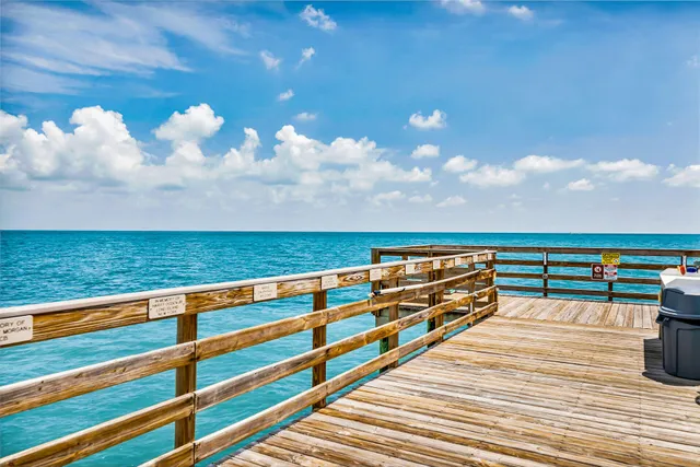 a view of an outdoor kitchen and swimming pool