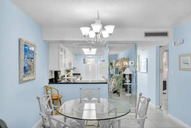 a large white kitchen with stainless steel appliances granite countertop a lot of counter space a sink and a window