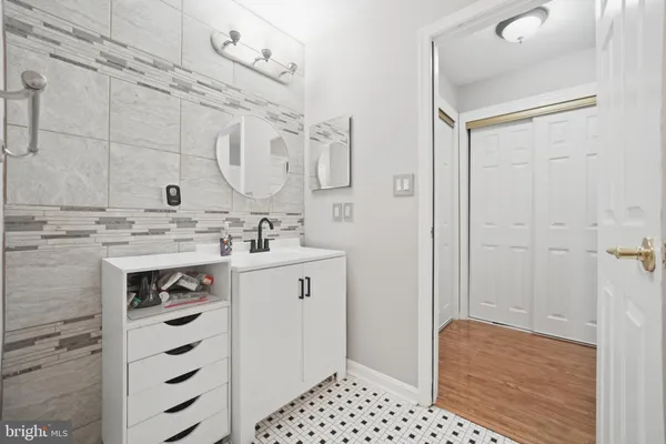 a bathroom with a sink a vanity and a mirror