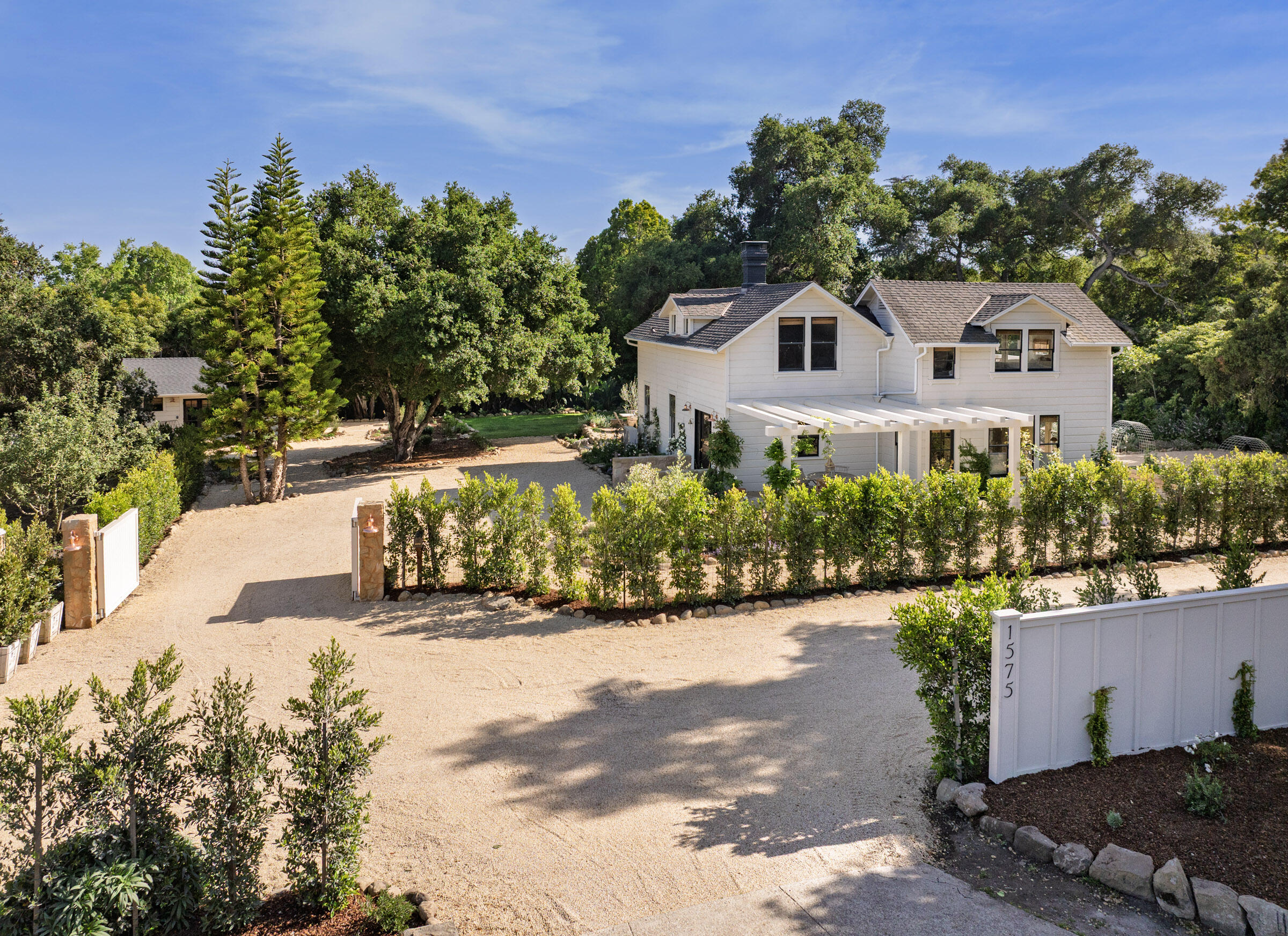 1575 East Valley Road Montecito, CA 93108 - Photo 2 of 30 a front view of a house with a yard
