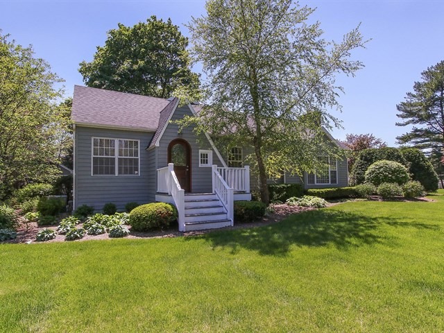 a front view of a house with a garden