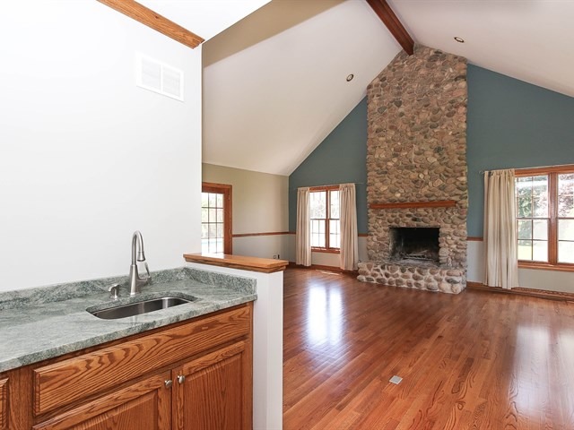 243 Bradwell Road Inverness, IL 60010 - Photo 13 of 25 a kitchen with stainless steel appliances granite countertop a sink dishwasher a stove and a wooden floor