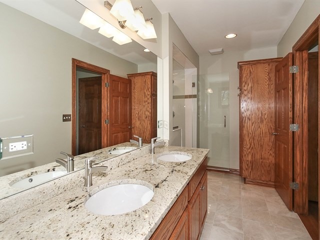 243 Bradwell Road Inverness, IL 60010 - Photo 15 of 25 a bathroom with a granite countertop sink and a mirror
