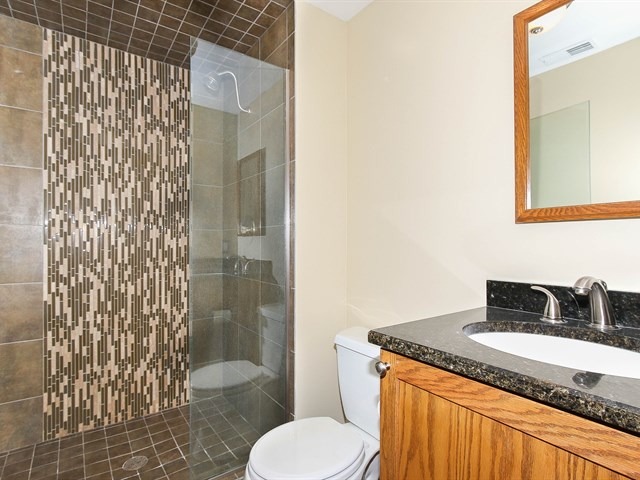 243 Bradwell Road Inverness, IL 60010 - Photo 19 of 25 a bathroom with a granite countertop sink toilet and shower