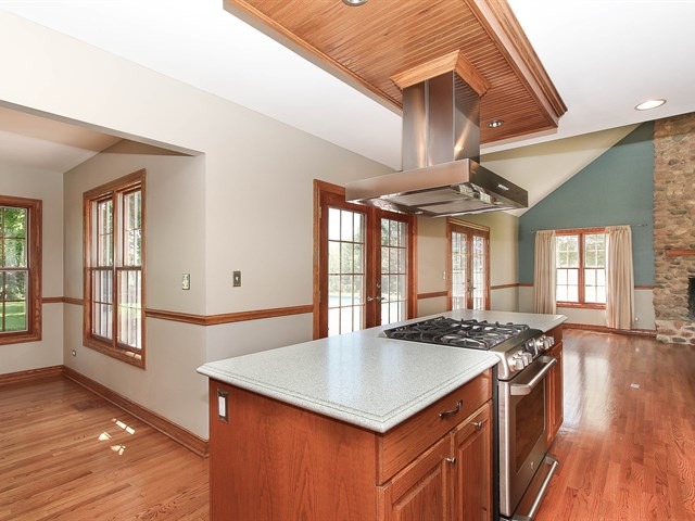 243 Bradwell Road Inverness, IL 60010 - Photo 7 of 25 a kitchen that has a sink a stove and wooden floors