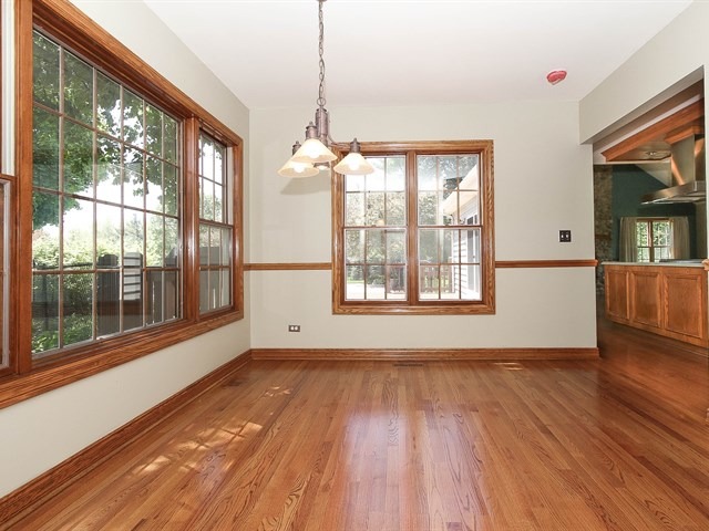 243 Bradwell Road Inverness, IL 60010 - Photo 8 of 25 a view of an empty room with wooden floor and a window
