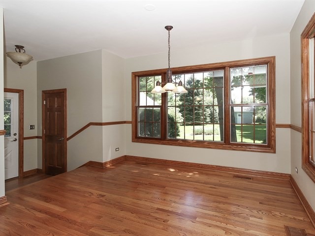 243 Bradwell Road Inverness, IL 60010 - Photo 9 of 25 a view of empty room with wooden floor and fan