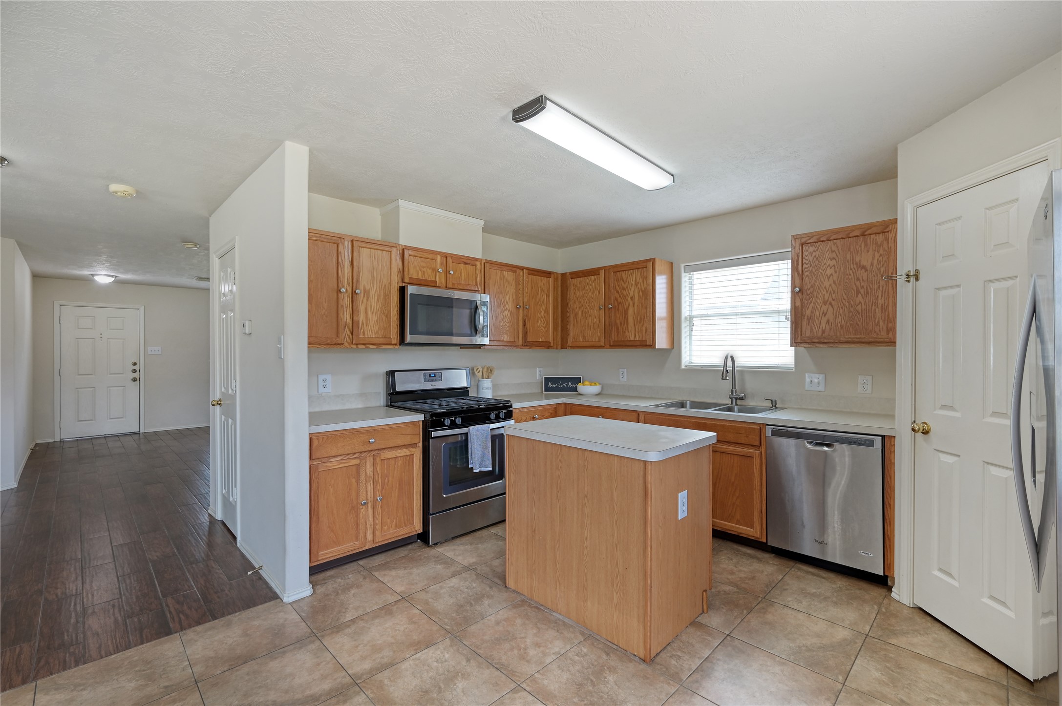 23919 Kingbriar Drive Spring, TX 77373 - Photo 15 of 33 Abundant cabinetry, a center island, and an efficient layout make this kitchen both practical and inviting.
