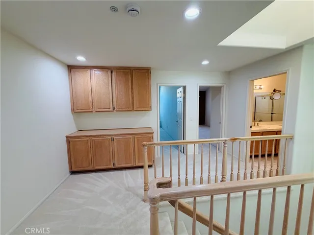 a view of an empty room with window and stairs
