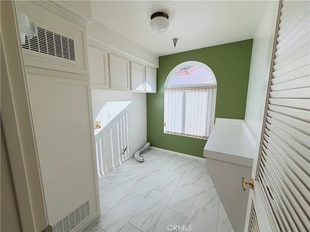 a view of a hallway view with staircase and door