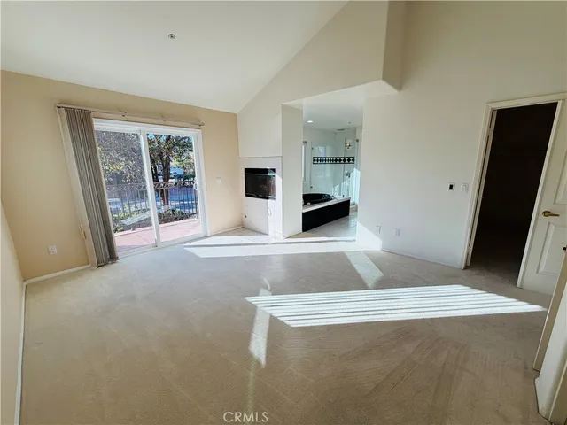 a view of an empty room with glass door