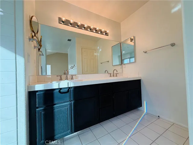 a bathroom with a double vanity sink mirror and