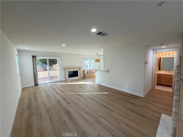 wooden floor in an empty room with a fireplace