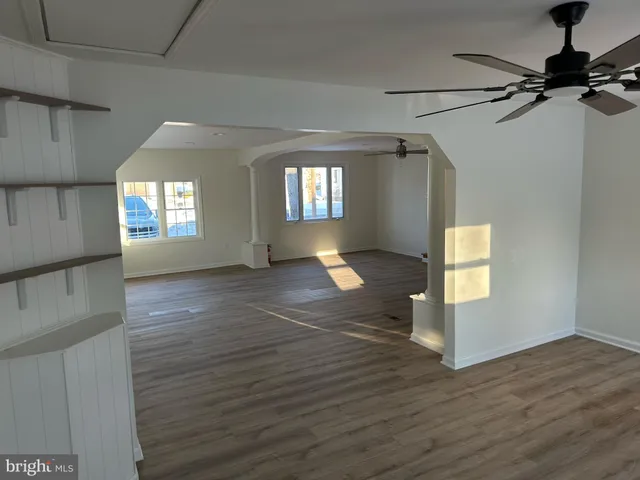 a view of a bathroom with wooden floor and a toilet