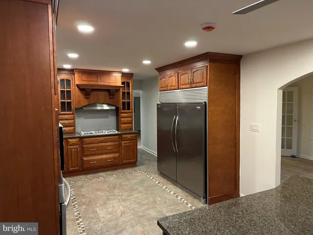 a kitchen with stainless steel appliances granite countertop a refrigerator and a sink