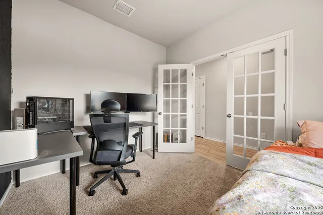 a view of a workspace with furniture and a window