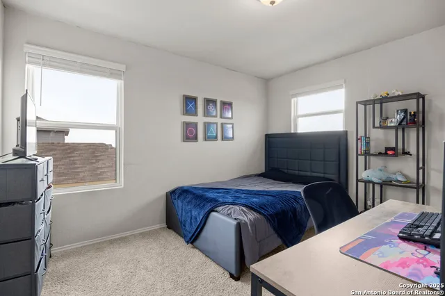 a bedroom with two beds and a window