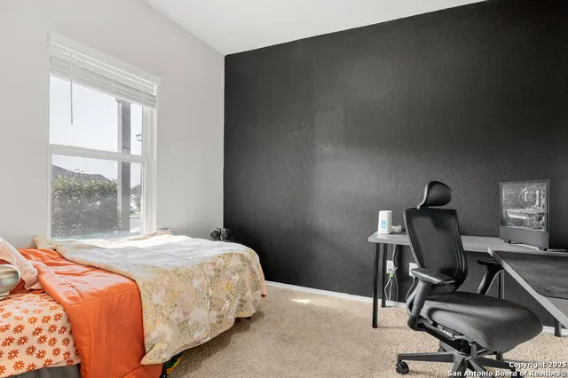 a bedroom with a bed chair and a window