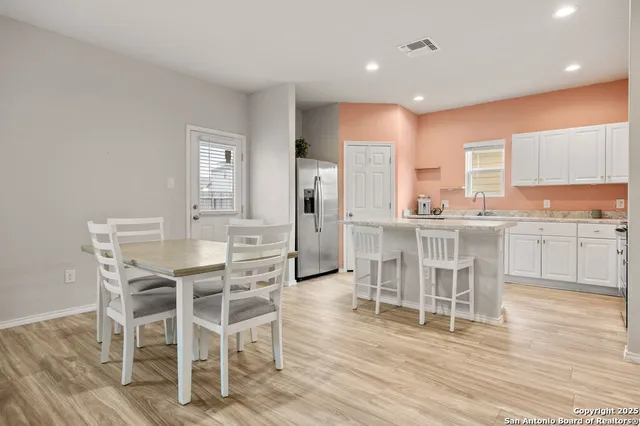 a dining room with furniture and wooden floor