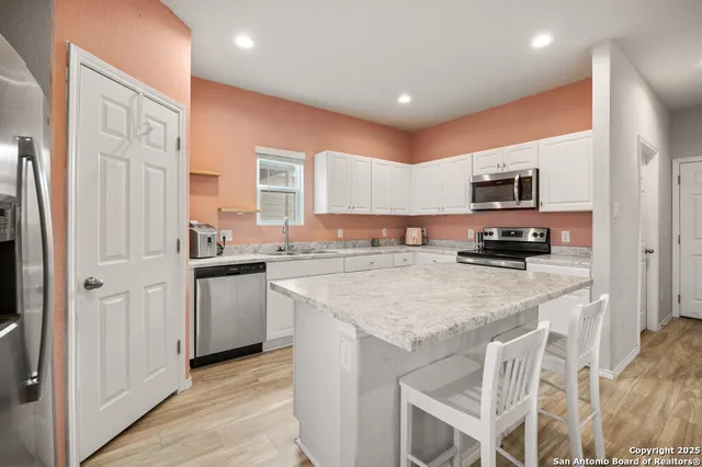 a kitchen with a sink a stove a refrigerator and a refrigerator