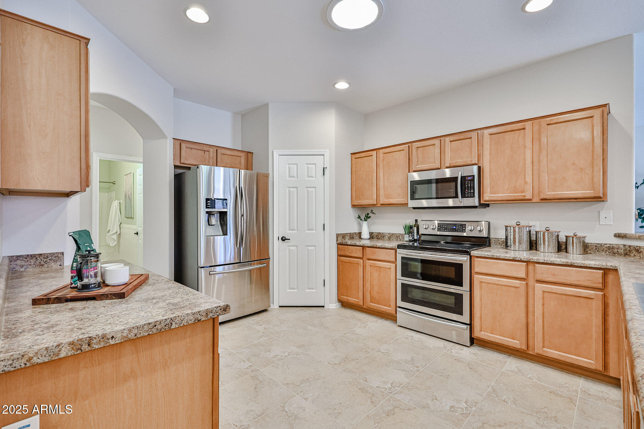 15731 West Redfield Road Surprise, AZ 85379 - Photo 13 of 48 a kitchen with granite countertop a refrigerator stove top oven a sink and dishwasher