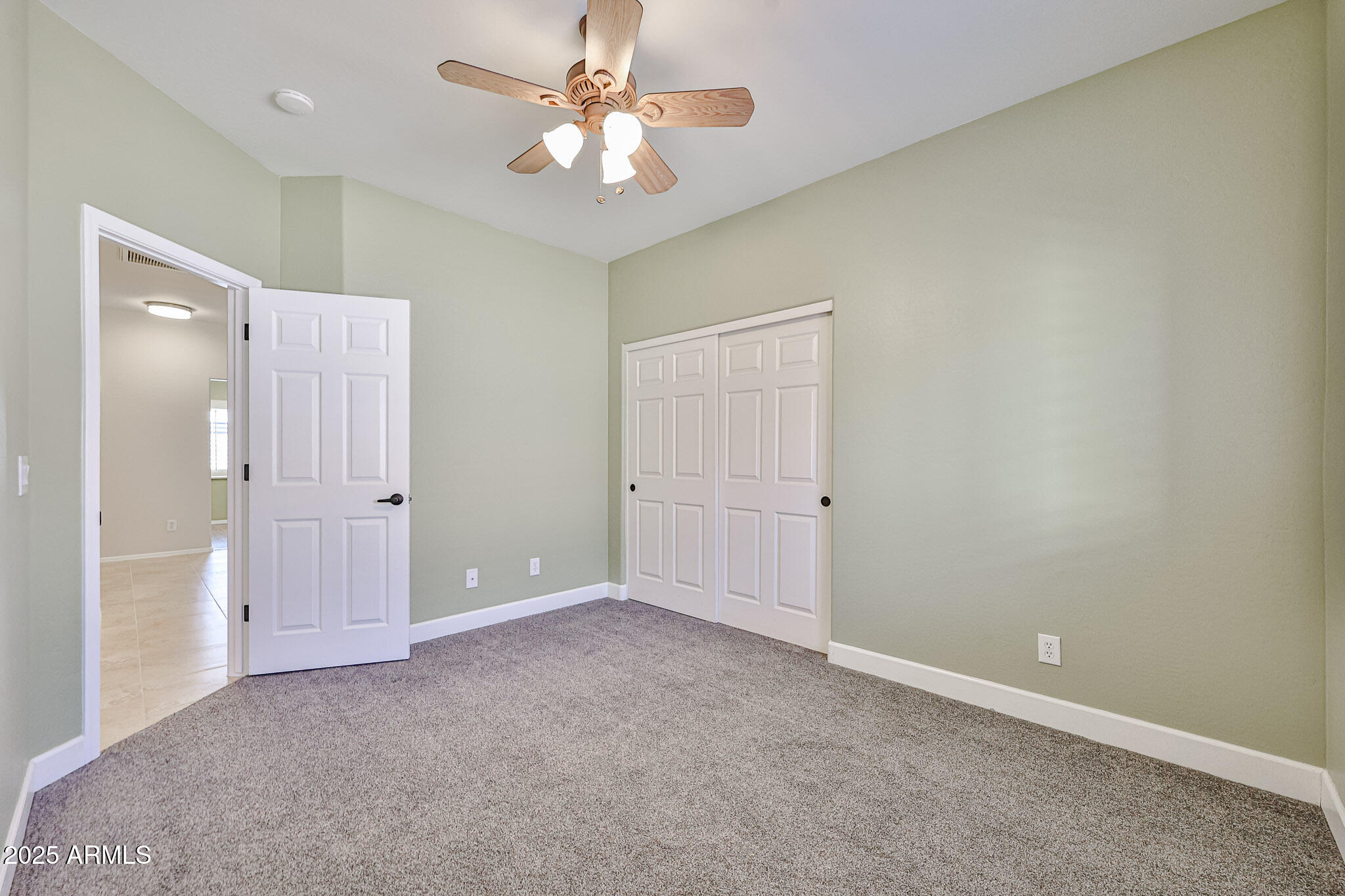 15731 West Redfield Road Surprise, AZ 85379 - Photo 24 of 48 an empty room with a ceiling fan and a bathroom