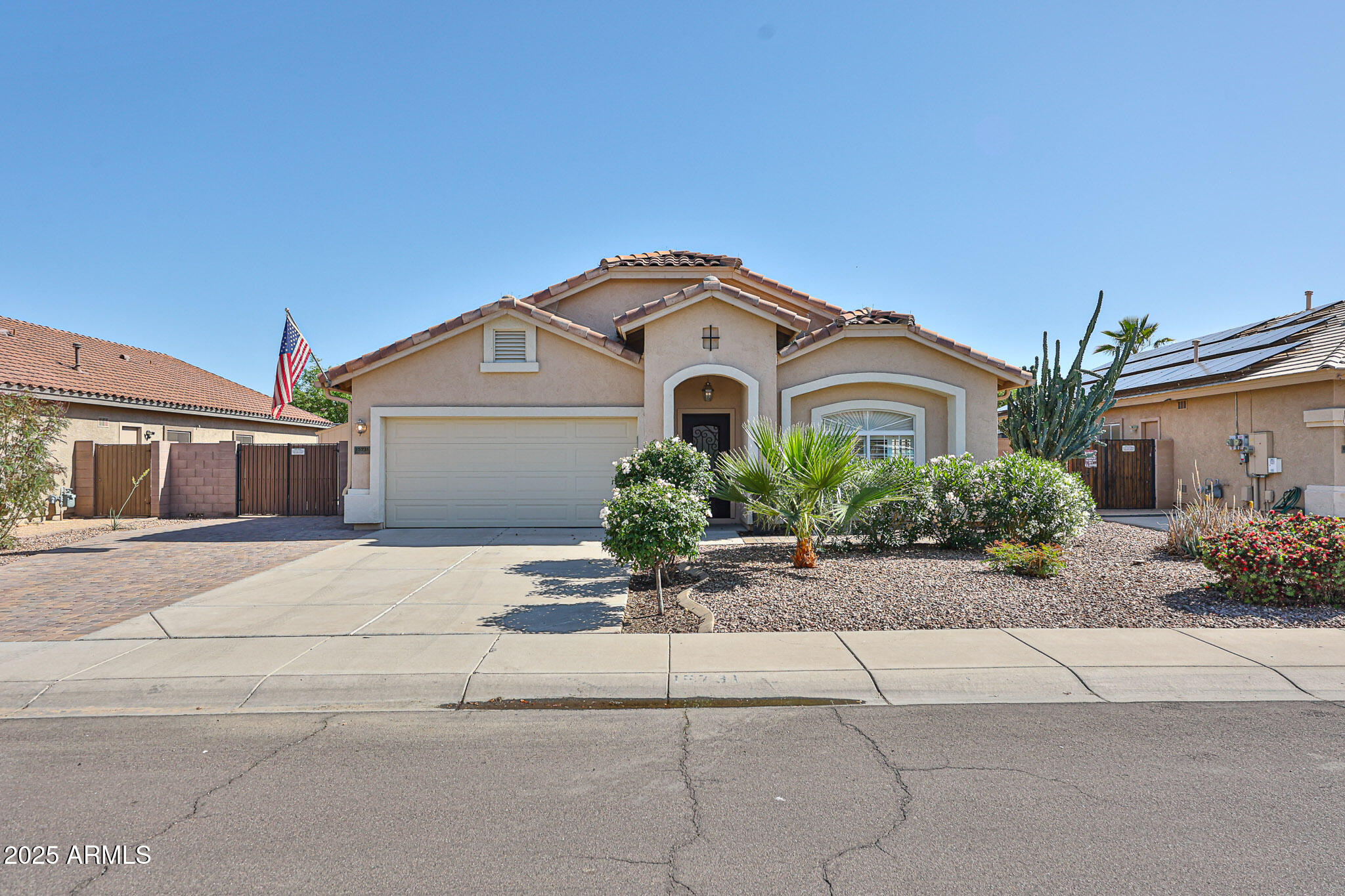 15731 West Redfield Road Surprise, AZ 85379 - Photo 3 of 48 a front view of a house with a garden
