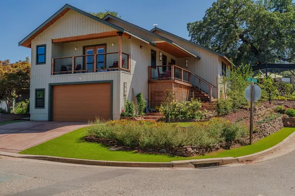 a bedroom with a bed a chandelier and a window