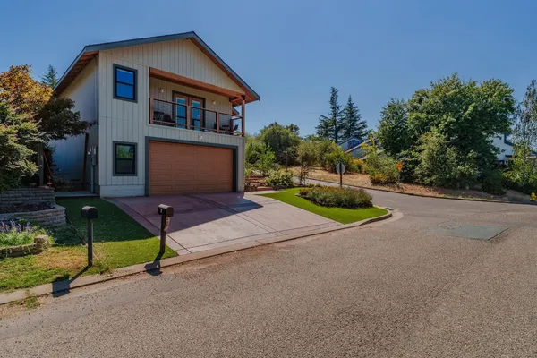 a bedroom with a bed and a dresser next to a window
