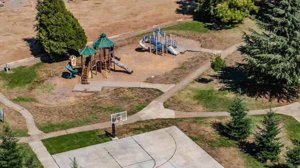 a open kitchen with stainless steel appliances granite countertop a sink a stove a dining table and chairs