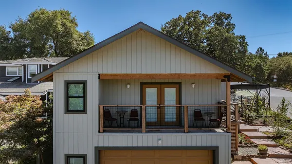 a kitchen with a table chairs microwave and cabinets
