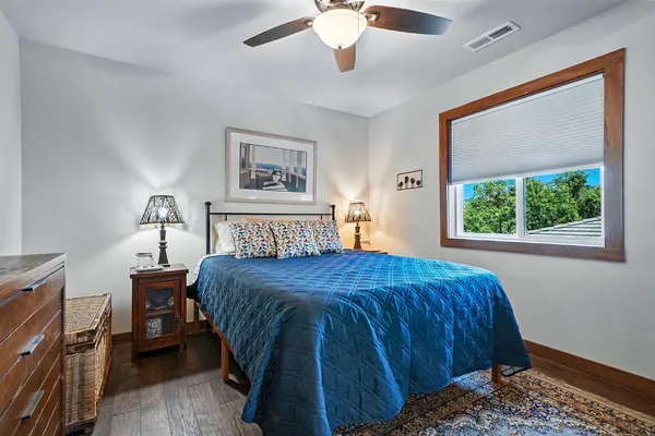 a living room with furniture a ceiling fan and a window