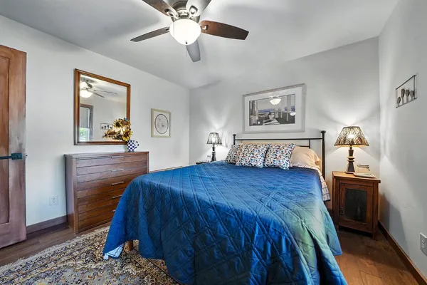 a living room with lots of furniture wooden floor and a table