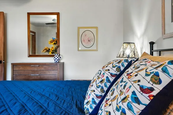 a living room with furniture kitchen view and a large window