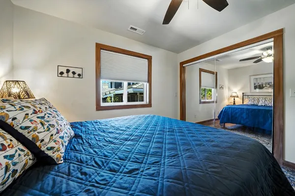 a bed room with furniture and a flat screen tv