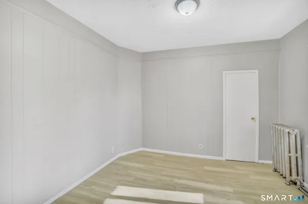 a view of a room with wooden floor