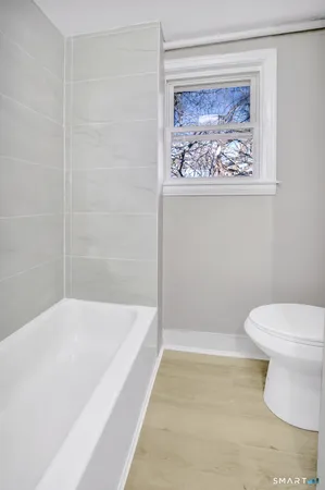 a bathroom with a toilet and a bathtub