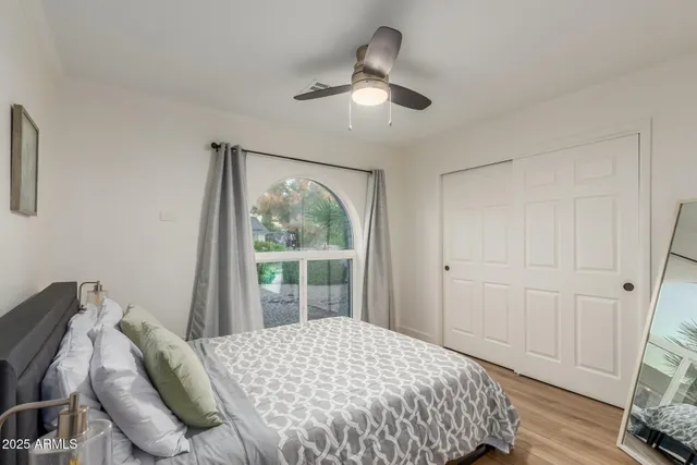 a bedroom with a bed and a window