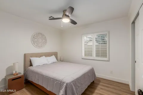 a bedroom with a large bed and a chandelier