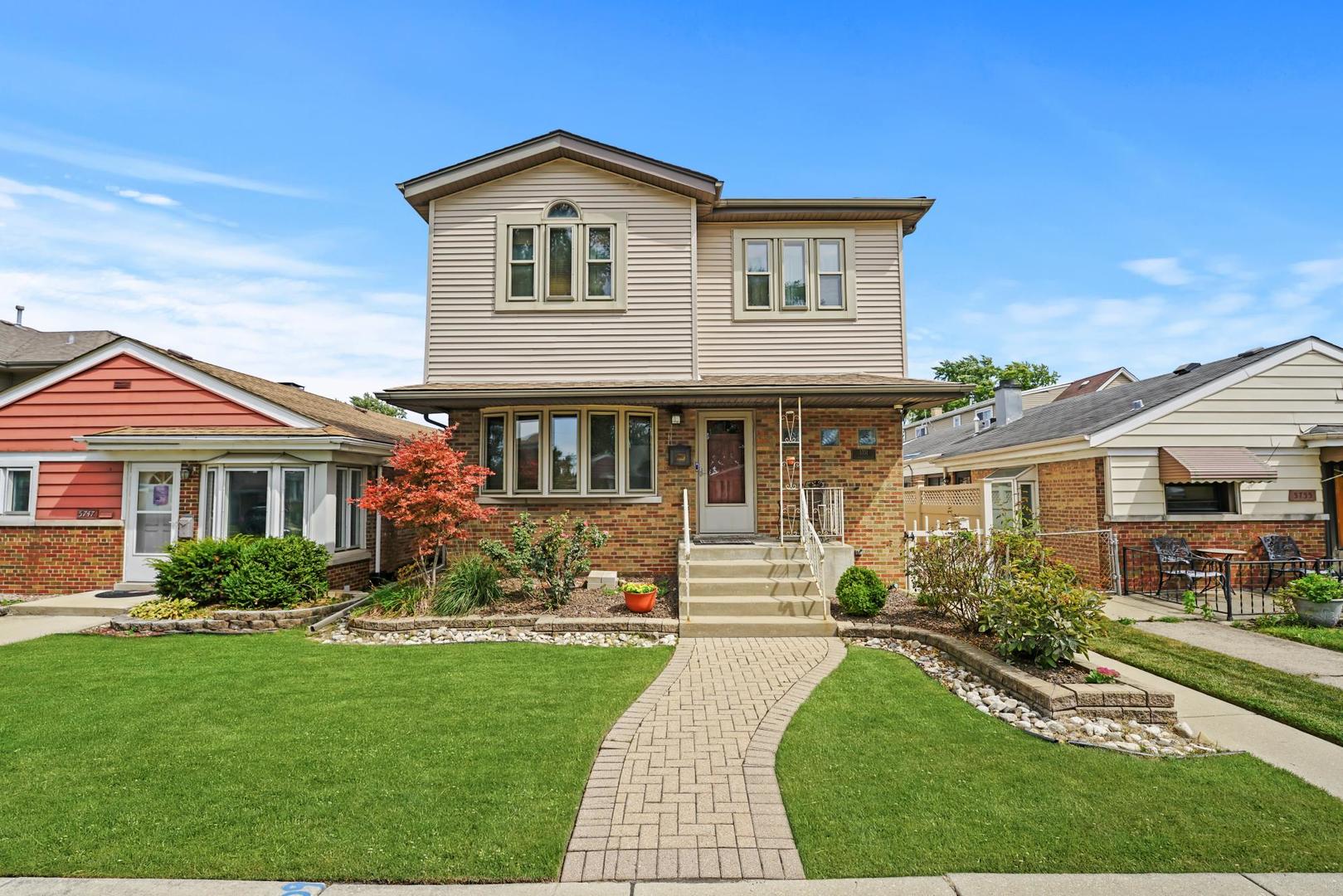 5751 South Monitor Avenue Chicago, IL 60638 - Photo 1 of 30 a front view of a house with a yard