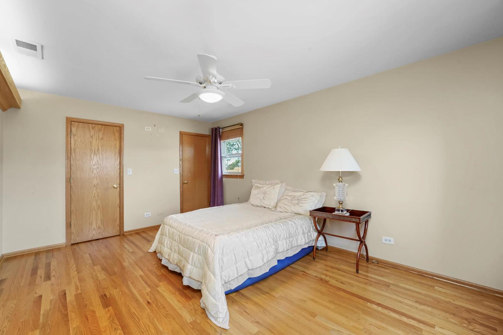 5751 South Monitor Avenue Chicago, IL 60638 - Photo 12 of 30 a bedroom with a bed and a lamp on table