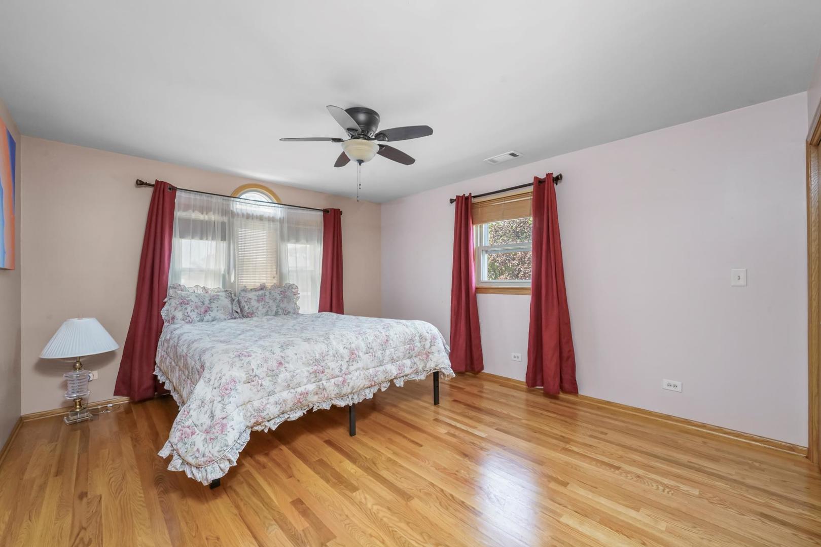 5751 South Monitor Avenue Chicago, IL 60638 - Photo 13 of 30 a bedroom with a bed and wooden floor