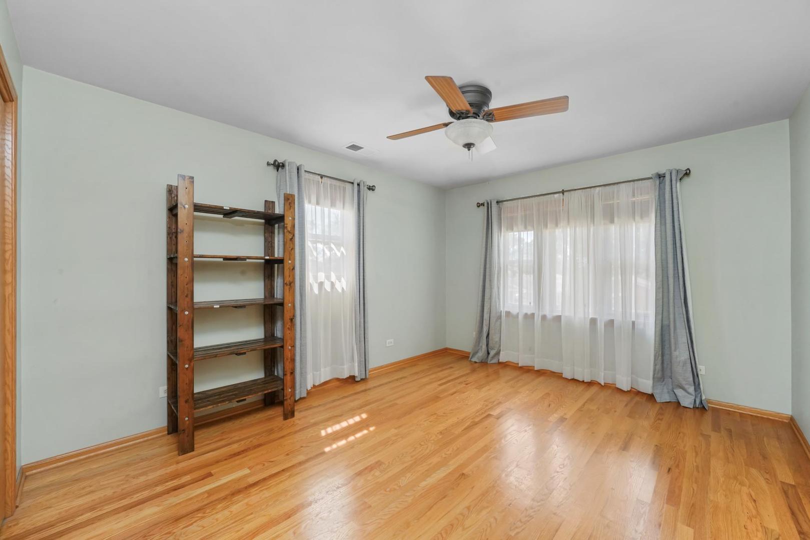 5751 South Monitor Avenue Chicago, IL 60638 - Photo 14 of 30 a view of empty room with wooden floor and fan