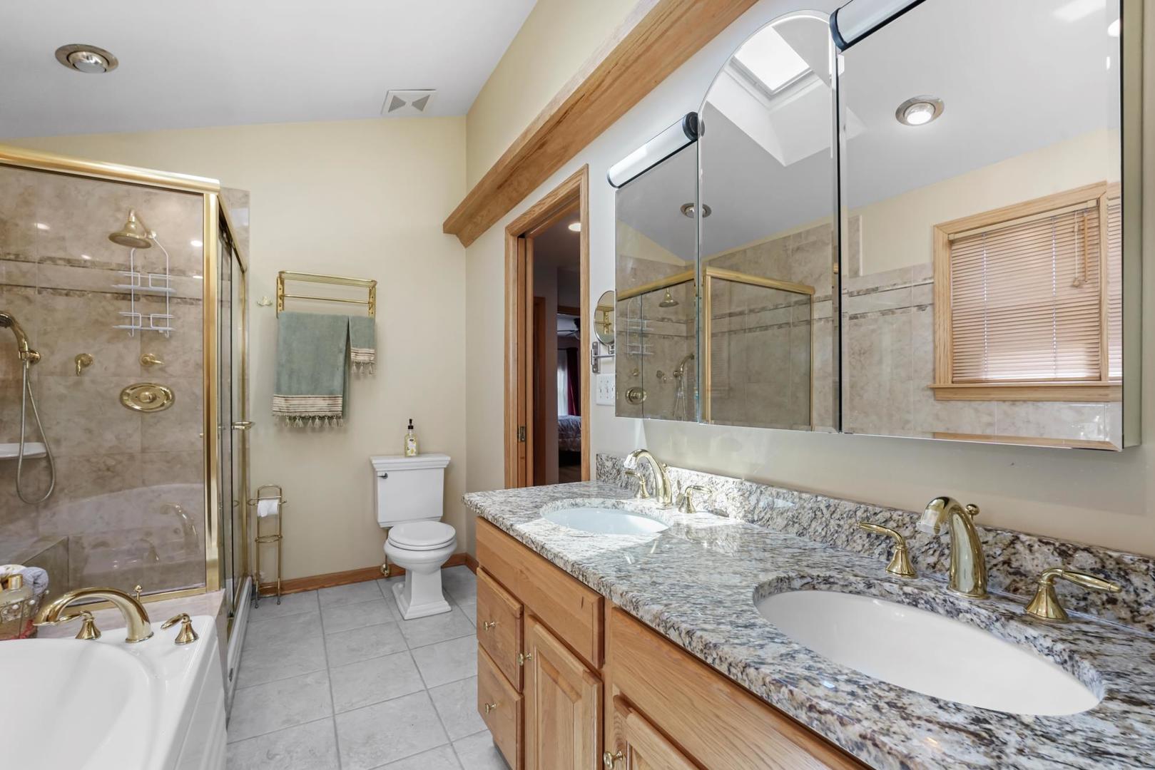 5751 South Monitor Avenue Chicago, IL 60638 - Photo 15 of 30 a bathroom with a granite countertop sink mirror and shower