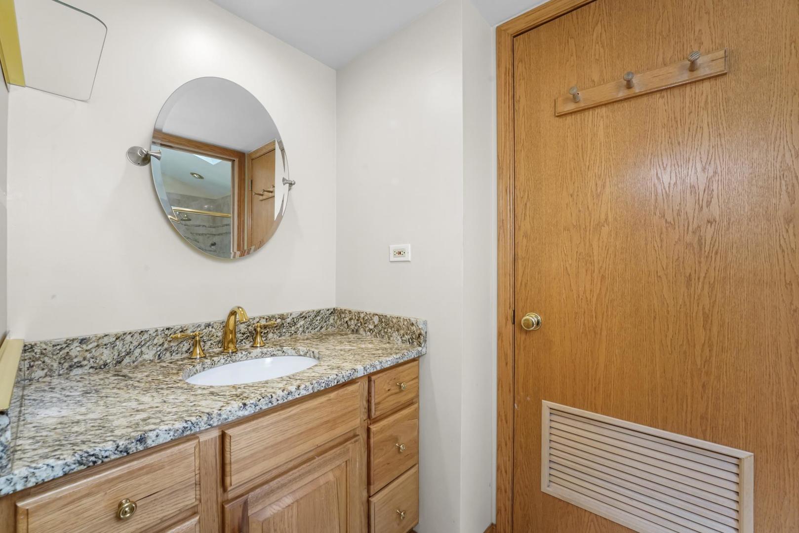 5751 South Monitor Avenue Chicago, IL 60638 - Photo 16 of 30 a bathroom with a sink and a mirror