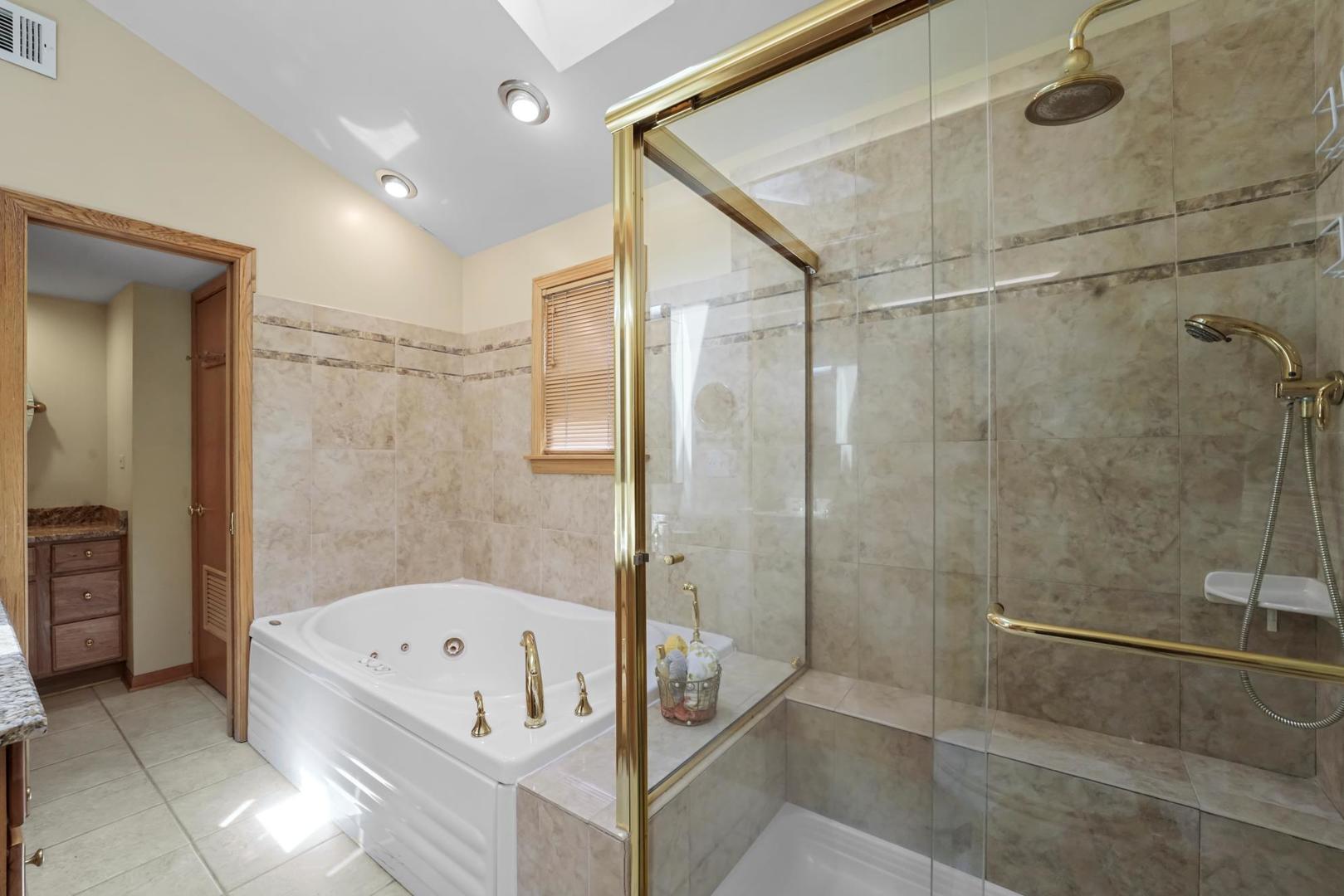 5751 South Monitor Avenue Chicago, IL 60638 - Photo 17 of 30 a bathroom with a bathtub and shower