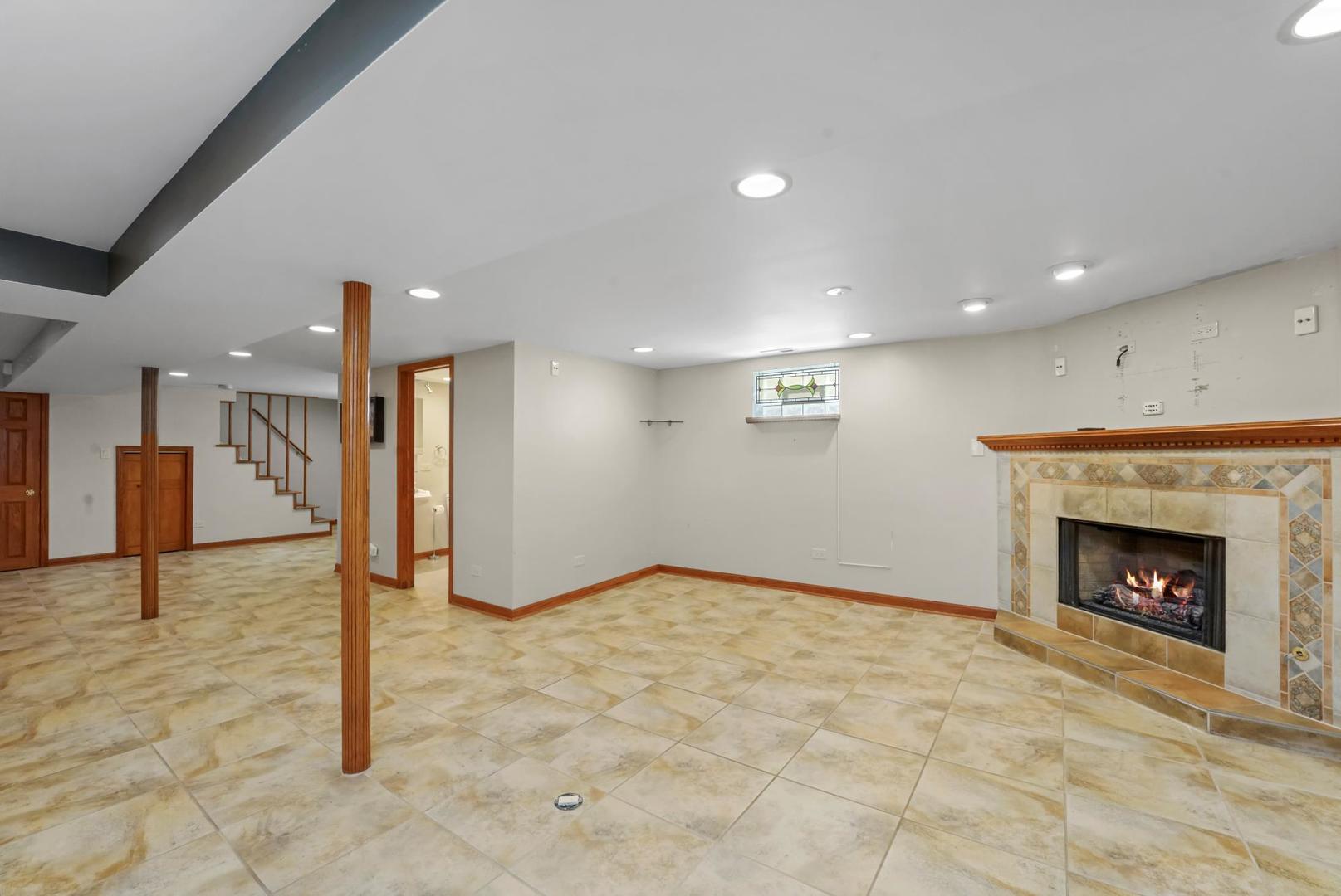 5751 South Monitor Avenue Chicago, IL 60638 - Photo 19 of 30 a view of an empty room with a fireplace