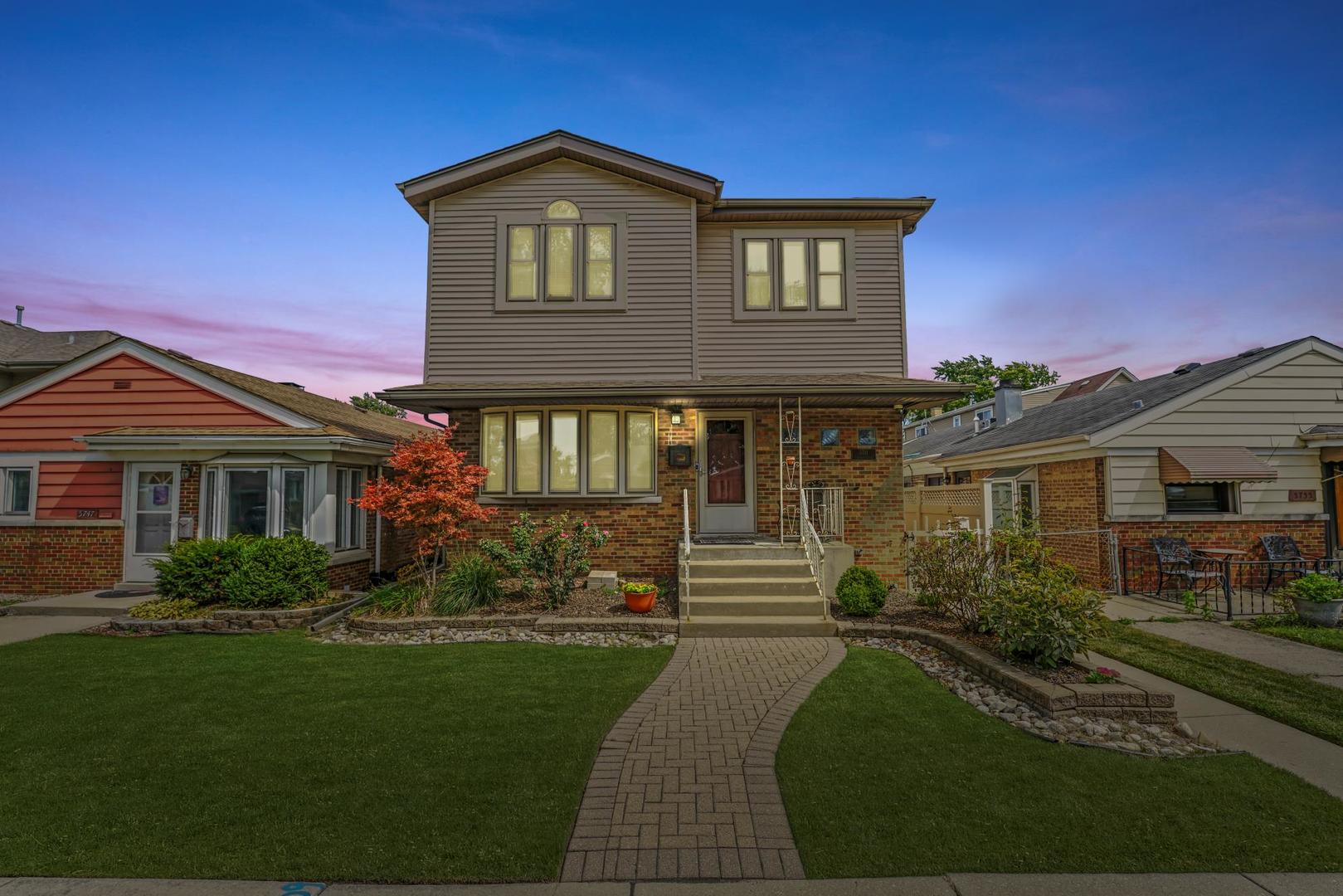 5751 South Monitor Avenue Chicago, IL 60638 - Photo 2 of 30 a front view of a house with a yard