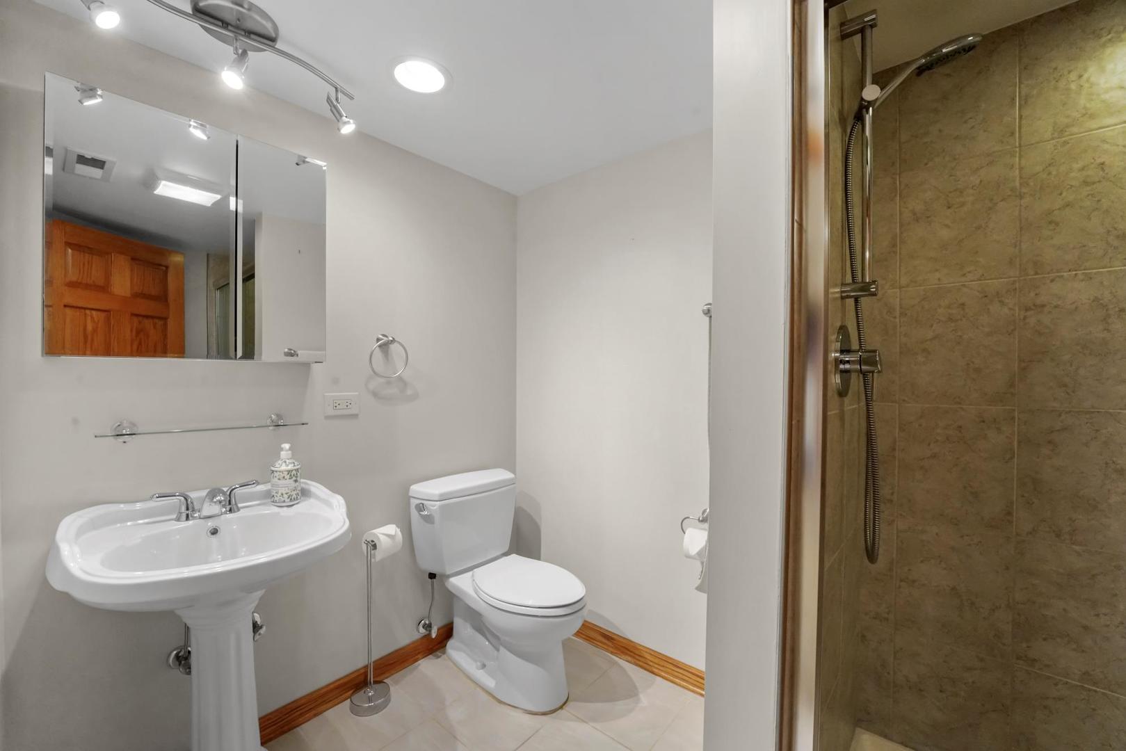 5751 South Monitor Avenue Chicago, IL 60638 - Photo 21 of 30 a bathroom with a toilet sink and mirror