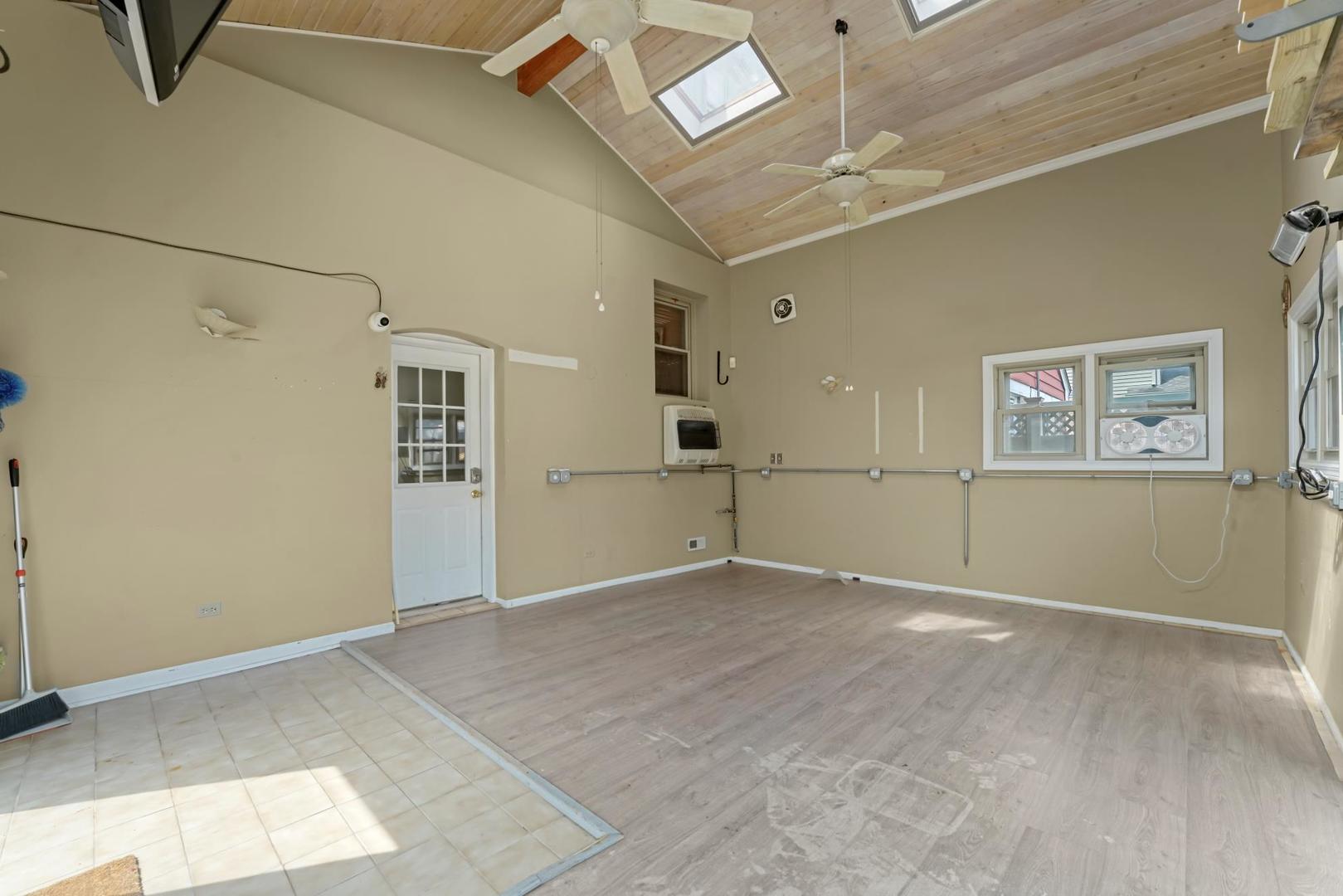 5751 South Monitor Avenue Chicago, IL 60638 - Photo 24 of 30 a view of a livingroom with a ceiling fan and window
